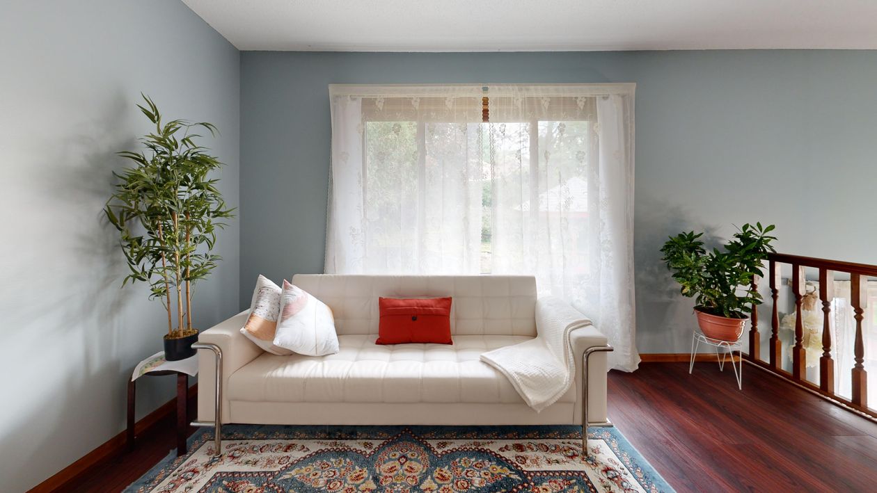 A bright, tidy living room with comfortable seating and natural light